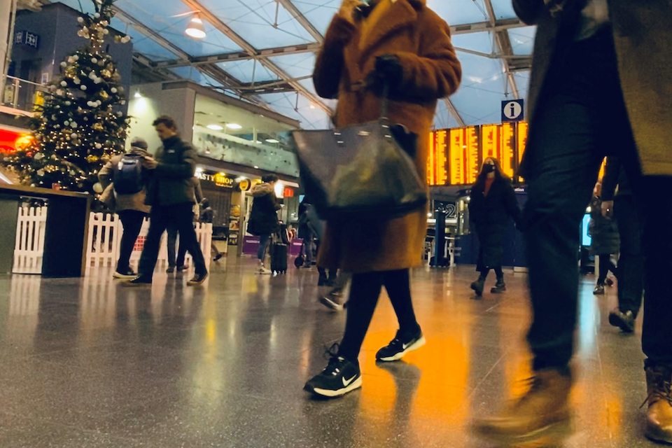 Footsteps across the concourse at Manchester Piccadilly station with Christmas tree in background