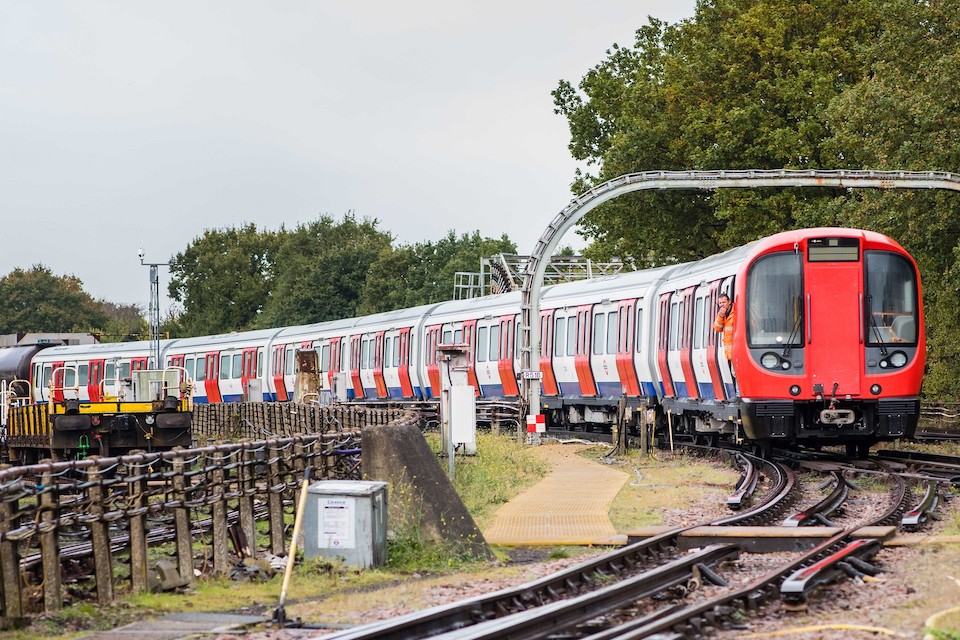 Picture of a London Underground train in the open air negotiating a tight curve