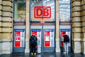 Passengers buy tickets from Deutsche Bahn